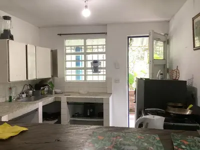 a kitchen with white cabinets and a large window at Hostal Las Hamacas,Habitación #5 in Villamaría