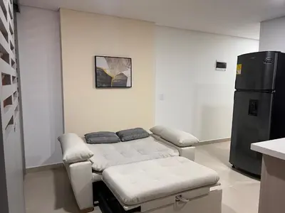a hospital room with a bed and a refrigerator at Apartasuite Sabaneta Vista a la ciudad parking in Sabaneta