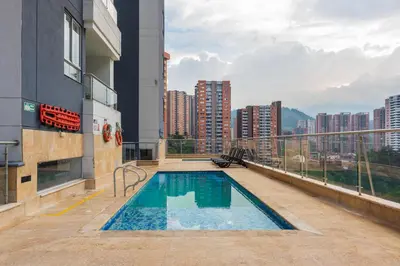 a swimming pool on the roof of a building at Apartasuite Sabaneta Vista a la ciudad parking in Sabaneta