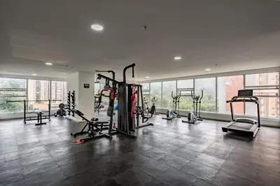 a gym with several tread machines in a large room at Apartasuite Sabaneta Vista a la ciudad parking in Sabaneta