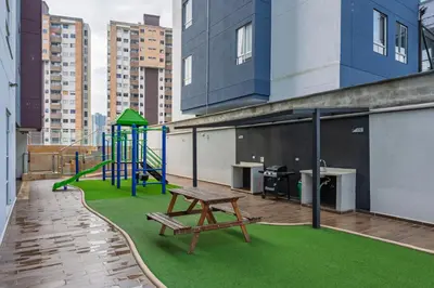 a playground on the roof of a building with a bench at Apartasuite Sabaneta Vista a la ciudad parking in Sabaneta