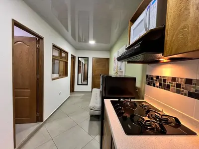 a kitchen with a stove top oven in a room at Apartamento Carmelina-solo a dos cuadras del parque in Carmen de Viboral