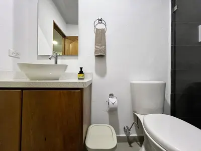 a white bathroom with a sink and a toilet at Apartamento Carmelina-solo a dos cuadras del parque in Carmen de Viboral