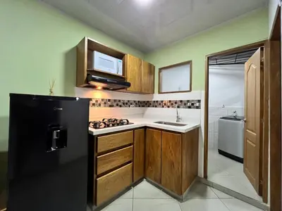 a kitchen with a black refrigerator and a sink at Apartamento Carmelina-solo a dos cuadras del parque in Carmen de Viboral