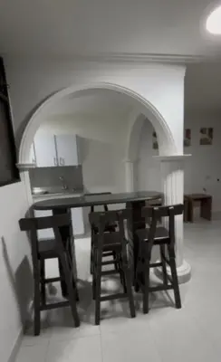a dining room table with chairs and an archway at CÓMODO APARTAMENTO CERCA De TODO EN ENVIGADO in Envigado