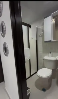 a bathroom with a white toilet and a sink at CÓMODO APARTAMENTO CERCA De TODO EN ENVIGADO in Envigado