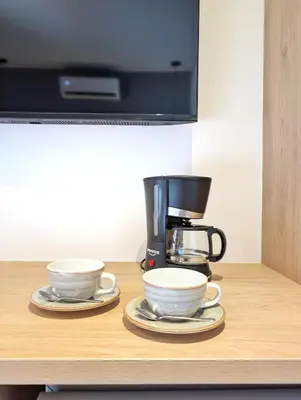 two cups on a counter with a coffee maker at Moa Select in Medellín