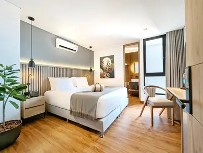 a hotel room with a bed and a desk at Moa Select in Medellín