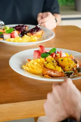 two plates of breakfast food on a table at Moa Select in Medellín