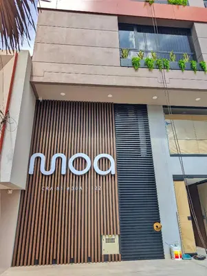 a sign on the front of a building at Moa Select in Medellín