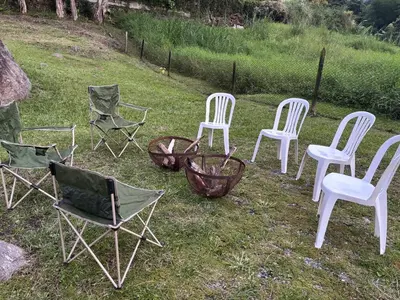 a group of chairs sitting in the grass at Cozy villa near El Poblado in Envigado