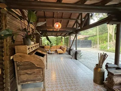 a covered patio with a couch and a table at Cozy villa near El Poblado in Envigado