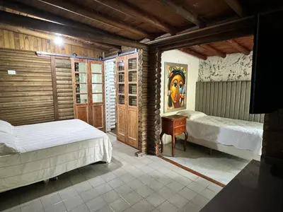 a bedroom with two beds and a desk in it at Cozy villa near El Poblado in Envigado