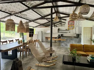 a living room with a wooden table and chairs at Cozy villa near El Poblado in Envigado