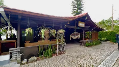 a building with plants hanging from the roof at Cozy villa near El Poblado in Envigado