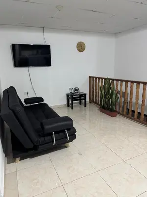 a black leather reclining chair in a living room at Casa Irene in Chinchiná