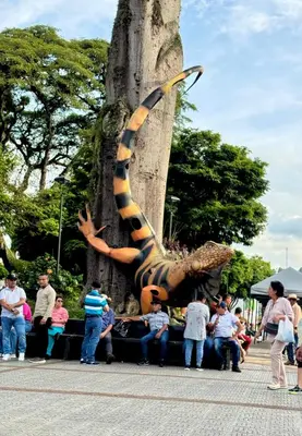 a large statue of a caterpillar leaning against a tree at Casa Irene in Chinchiná