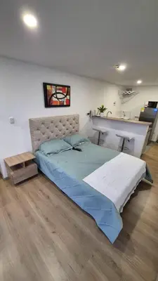 a bedroom with a large bed and a counter at Mirador del Ruiz Aparta Estudio in Manizales
