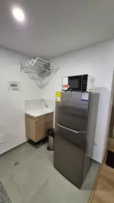 a kitchen with a microwave on top of a refrigerator at Mirador del Ruiz Aparta Estudio in Manizales