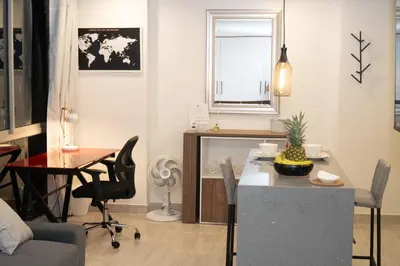 a living room with a table and a dining room at Staynova loft acogedor en El Poblado, Medellín in Medellín