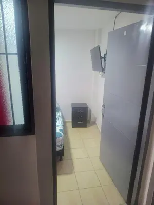 a kitchen with a white refrigerator in a room at La fonda in Santa Rosa de Cabal
