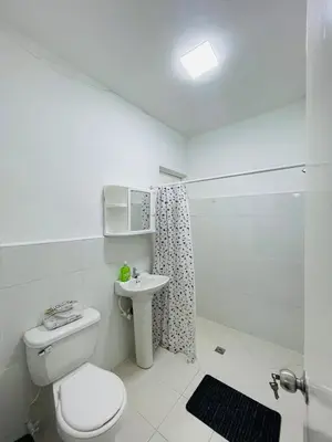 a bathroom with a toilet and a sink and a shower at Grandma's House in Medellín