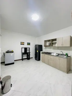 a large kitchen with a black refrigerator in a room at Grandma's House in Medellín