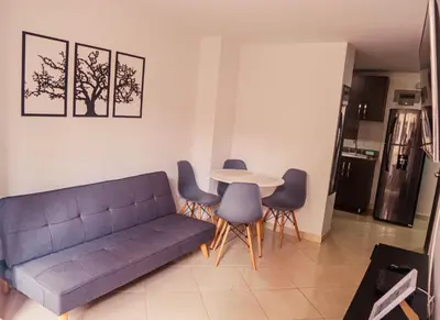a living room with a couch and a table and chairs at Apartamento en Sabaneta con Excelente Ubicación in Sabaneta