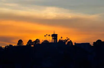 a silhouette of a city with a water tower at sunset at Acogedor Apartaestudio in Manizales