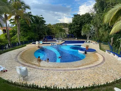 a large swimming pool with people in it at Apartasol En San Jeronimo in San Jerónimo