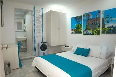 a bedroom with a large bed in a room at Almaviva Casa Hotel in Medellín