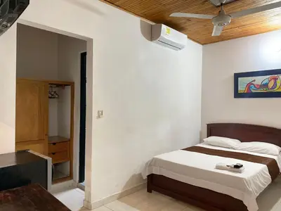 a bedroom with a bed and a tv in it at Hotel kerana moon in Puerto Boyacá