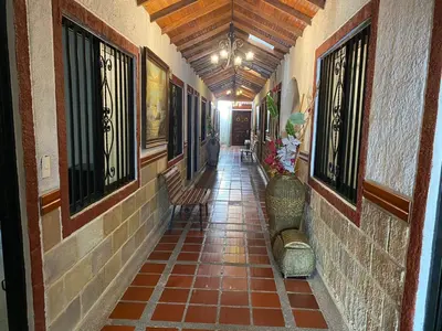 an empty hallway with benches in a building at Hotel kerana moon in Puerto Boyacá