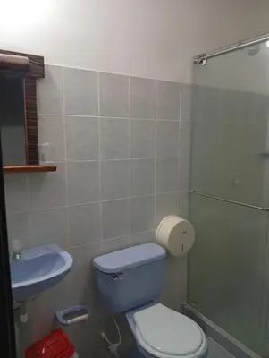 a bathroom with a blue toilet and a sink at Hotel kerana moon in Puerto Boyacá