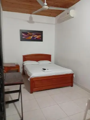 a small bedroom with a bed and a table at Hotel kerana moon in Puerto Boyacá
