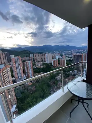 a balcony with a table and a view of a city at comodo y acogedor apartamento in Sabaneta