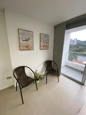 two chairs sitting in a room with a window at comodo y acogedor apartamento in Sabaneta