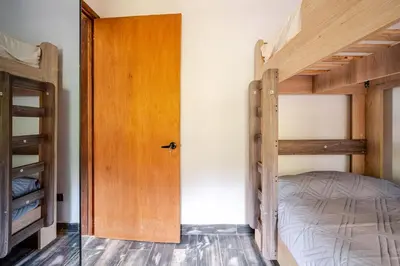 a bedroom with two bunk beds and a door at Nature Retreat Views, Grill, Jacuzzi & Glamping in Guarne