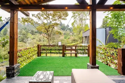 a view of a garden from the patio of a house at Nature Retreat Views, Grill, Jacuzzi & Glamping in Guarne