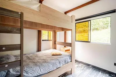 a bedroom with bunk beds in a tiny house at Nature Retreat Views, Grill, Jacuzzi & Glamping in Guarne