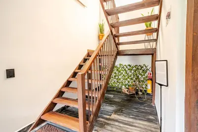 a staircase in a house with wooden floors at Nature Retreat Views, Grill, Jacuzzi & Glamping in Guarne