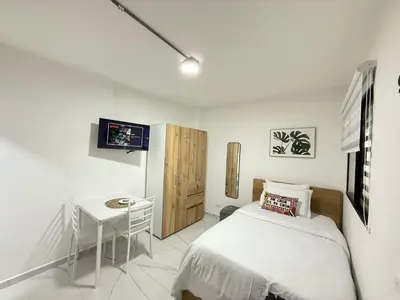 a bedroom with a bed and a small table at Casa Bendita - Apto 102 in Medellín