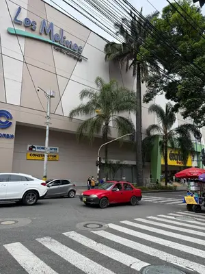 a red car on a street in front of a store at Casa Bendita - Apto 102 in Medellín