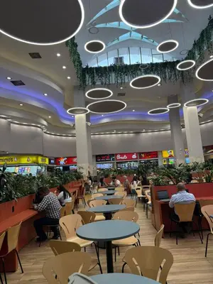 a restaurant with people sitting at tables in a mall at Casa Bendita - Apto 102 in Medellín