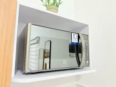 a microwave oven on a shelf in a room at Casa Bendita - Apto 102 in Medellín