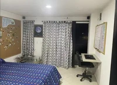 a bedroom with a bed and a desk and curtains at Habitaciones Privadas, dentro de apartamento, cómodas y muy cercanas al Poblado in Medellín