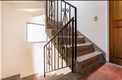 a staircase with wrought iron railings in a house at Habitaciones Privadas, dentro de apartamento, cómodas y muy cercanas al Poblado in Medellín