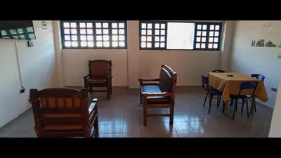 a dining room with a table and chairs and windows at Hotel San Judas in Santa Fe de Antioquia
