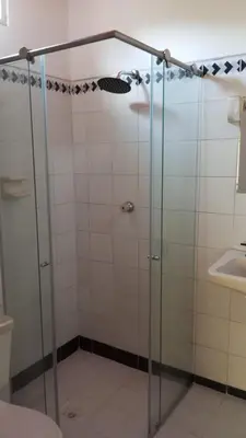 a shower with a glass door in a bathroom at Hotel San Judas in Santa Fe de Antioquia