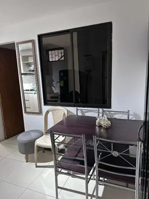 a living room with a table and a large television at Apartamento laureles estadio N 203 in Medellín